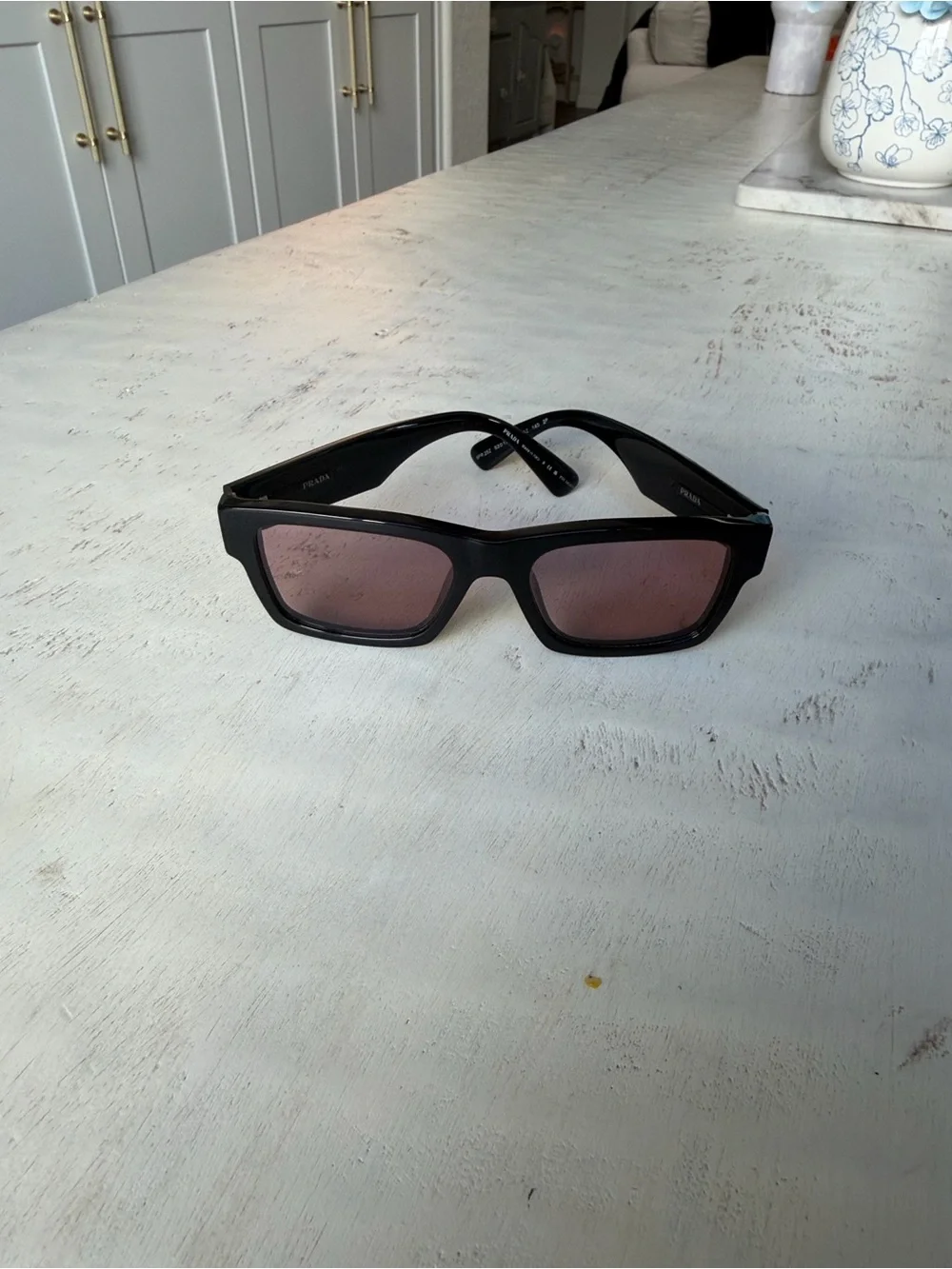 Prada Black Frame Sunglasses with Rose-Tinted Lenses